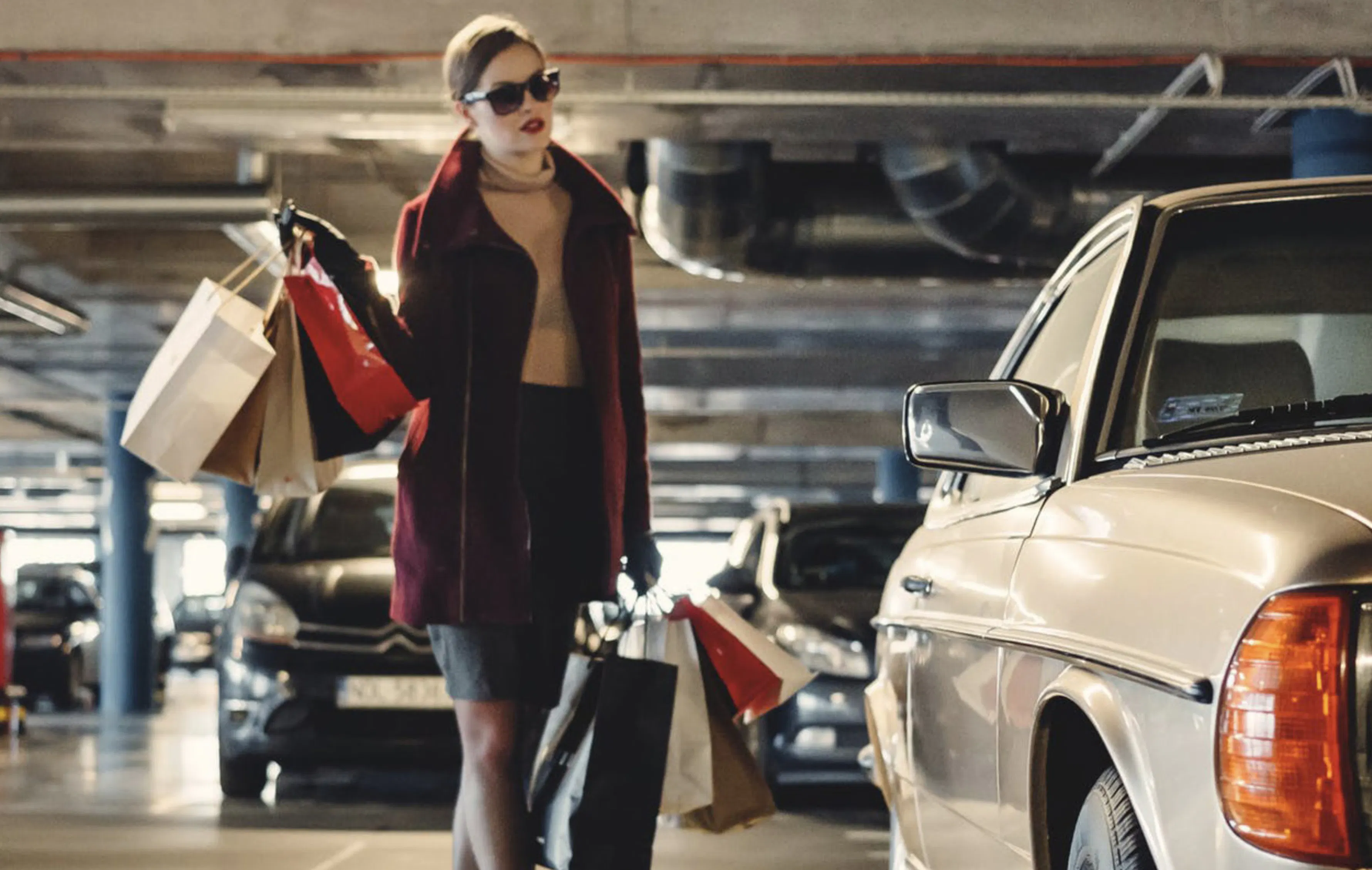 Woman shopping walking to a car in parking lot picture